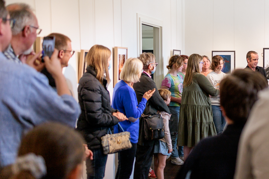 A crowd gathered at an exhibition opening