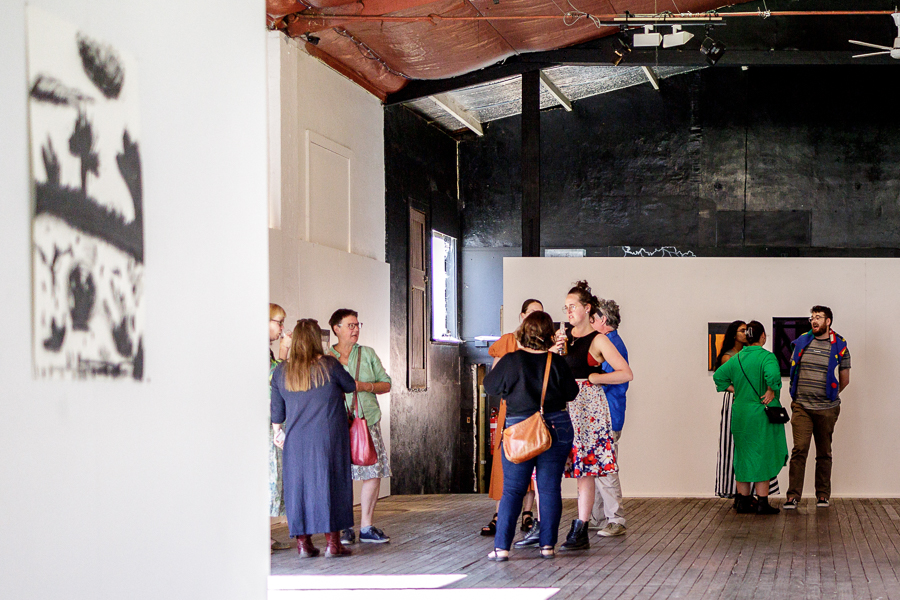 People mingling at an art exhibition opening